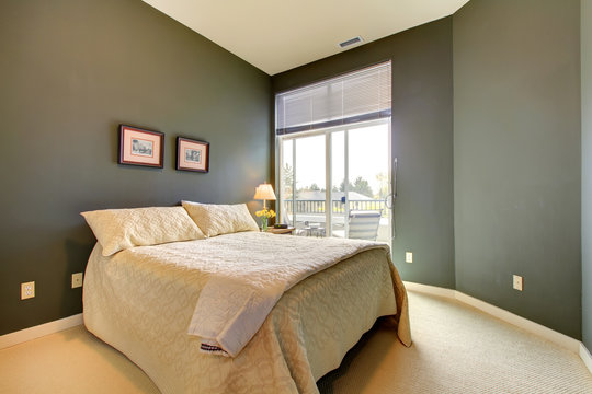 Bedroom wiht grey green walls and white bedding.