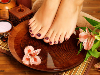 female feet at spa salon on pedicure procedure
