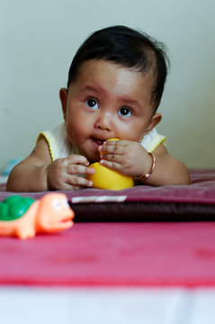 baby girl playing on the matress alone