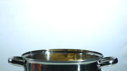 Tagliatelle falling into a saucepan - Powered by Adobe