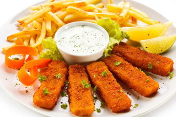 Fried fish fingers, French fries and vegetables
