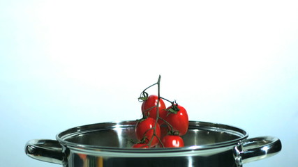 Vine tomatoes and parsnip falling in saucepan - Powered by Adobe