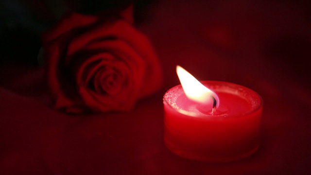 Pink candle and red rose