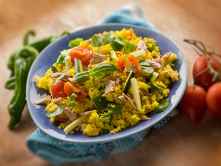 cold sald with couscous tuna zucchinis tomatoes, selective focus