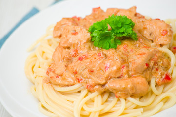 chicken breast with vegetables in a creamy sauce with pasta