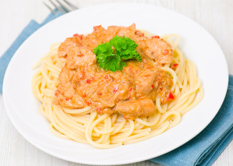 chicken breast with vegetables in a creamy sauce with pasta