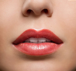 Close up of red glossy female lips