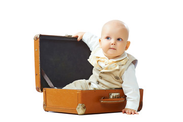 Baby sit in old-fashioned suitcase