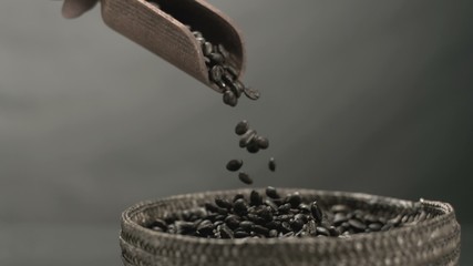 Hand pouring coffee beans in slow motion - Powered by Adobe