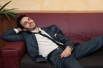 Fototapeta premium Young businessman relaxing on sofa.