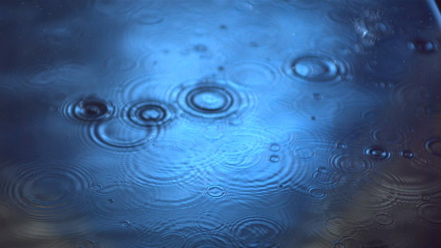 Rain on water in slow motion