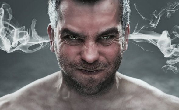 Close up of angry man with steam coming out from his ears