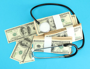Healthcare cost concept: stethoscope and dollars