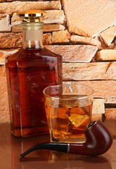 Bottle and Glass of whiskey and snorkel on brick wall