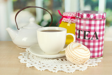 Jar and cup of tea isolated on white