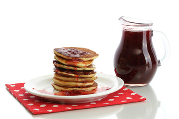 Sweet pancakes on plate with condensed milk isolated on white