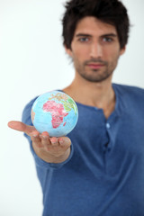 man holding a globe