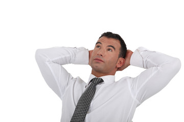 Businessman stretching his arms behind his head