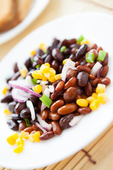 several kinds of beans on a white plate