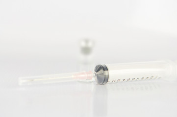 Syringe and  medicine vial on white background