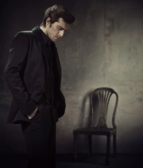Handsome man in a business suit on a dark background