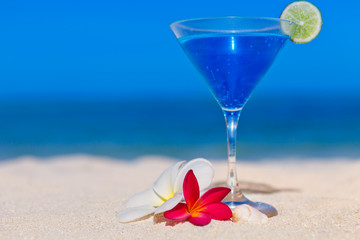 blue cocktail at tropical beach
