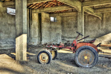 Old abandoned tractor in a garage