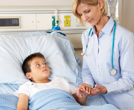 Doctor Visiting Child Patient On Ward