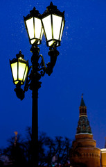 outdoor lantern and Kremlin tower in winter snowing evening