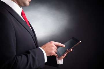 business man working with a tablet computer on black background