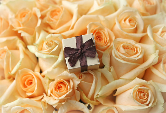 gift box on beautiful roses background