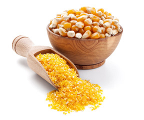corn grain and corn groats in a wooden bowl isolated