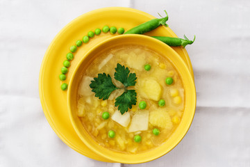 Meatless soup in round yellow cup.