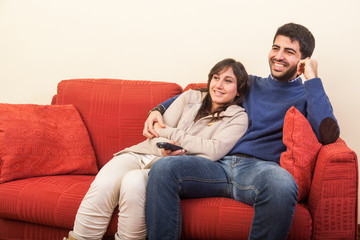 Young Couple Watching TV on the Sofa