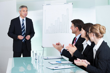 Colleagues clapping after a staff presentation
