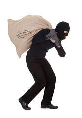 Thief carrying a large bag of money