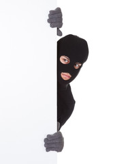 Thief looking around a blank sign