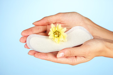 woman's hand holding a daily sanitary pad