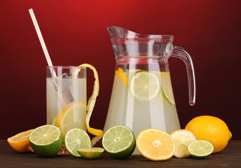 Citrus lemonade in pitcher and glass of citrus around