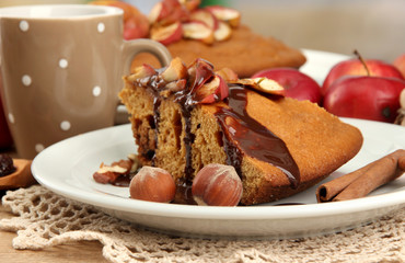 slice of tasty homemade pie with chocolate and apples and cup