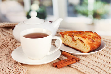 cup of tea with scarf on table in room