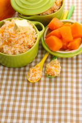 Taste rice porridge with pumpkin in saucepans