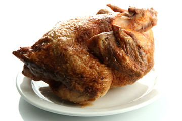 Tasty whole roasted chicken on plate, isolated on white