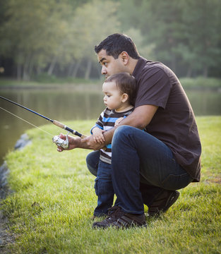 Happy Young Ethnic Father And Son Fishing