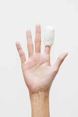 White medicine bandage on human injury hand finger