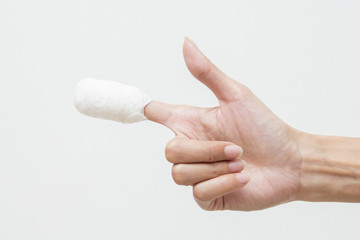 White medicine bandage on human injury hand finger