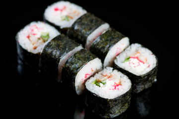 Set of Dragon rolls on a black plate, studio shot