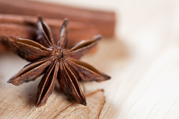 Macro shot of a star anise and cinnamon on a wooden background