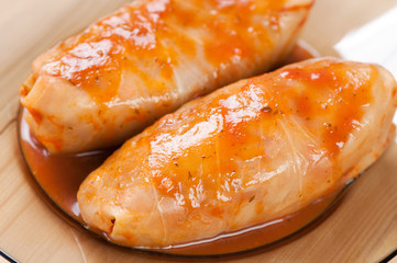 Still life food: stuffed cabbages with tomato sauce