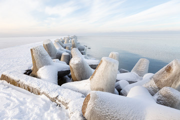 Pier concrete blocks covered with ice